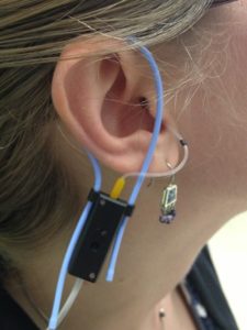 A woman's ear wearing real-ear measurement equipment